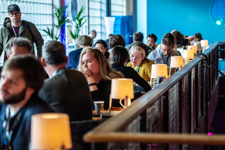 Conferentie in De Oosterpoort met zittende conferentiebezoekersen conferentiebezoekers