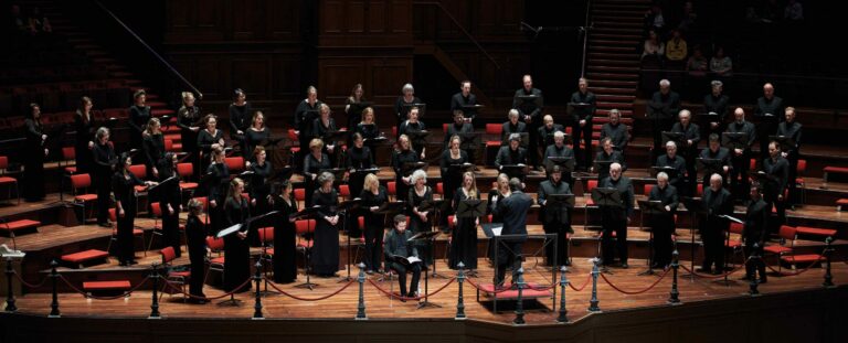 Grote a capella groep in zwart gekleed.