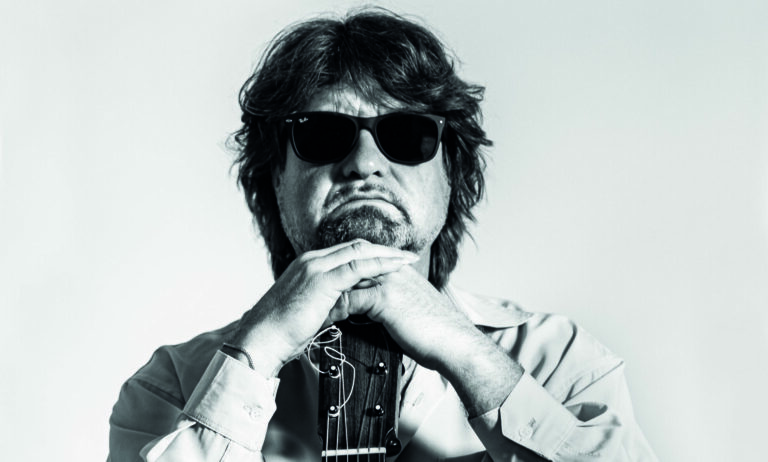 Een zwartwit foto van Eric Vaarzon Morel met een zwarte zonnebril op.