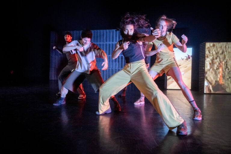 Performers staan wijdbeens met gebalde vuisten